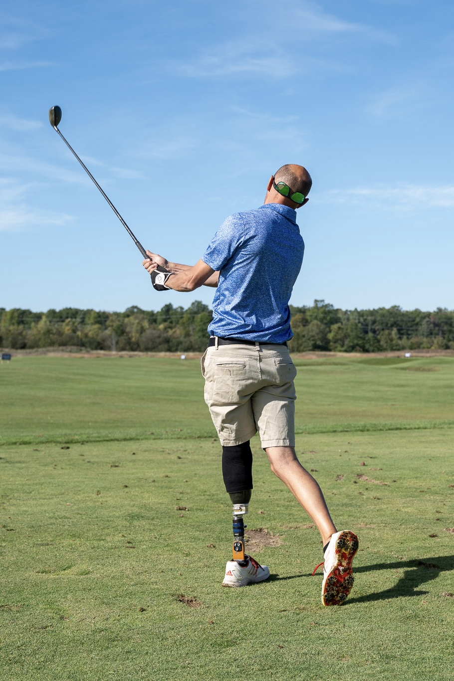 Amputee Golfer swinging at a golf ball
