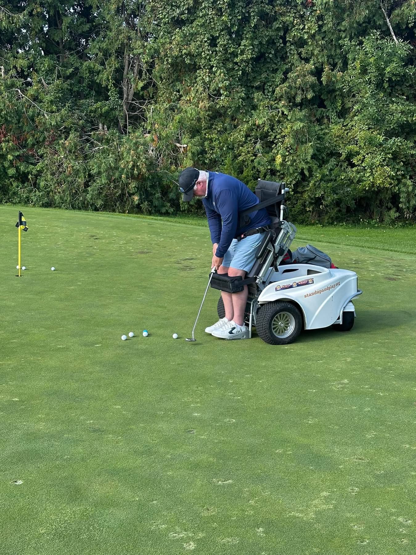 Amputee Golfer swinging at a golf ball