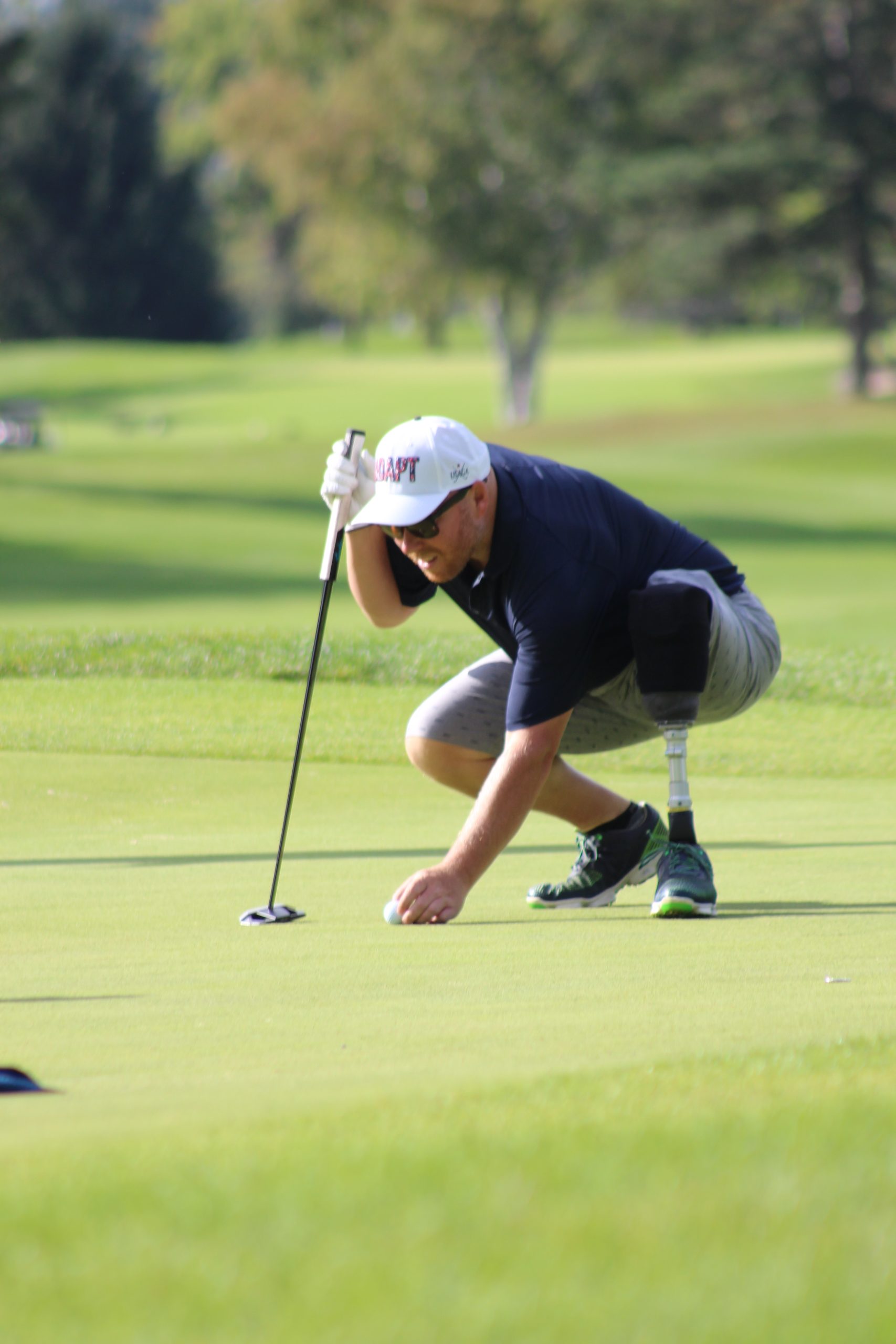 Amputee Golfer swinging at a golf ball
