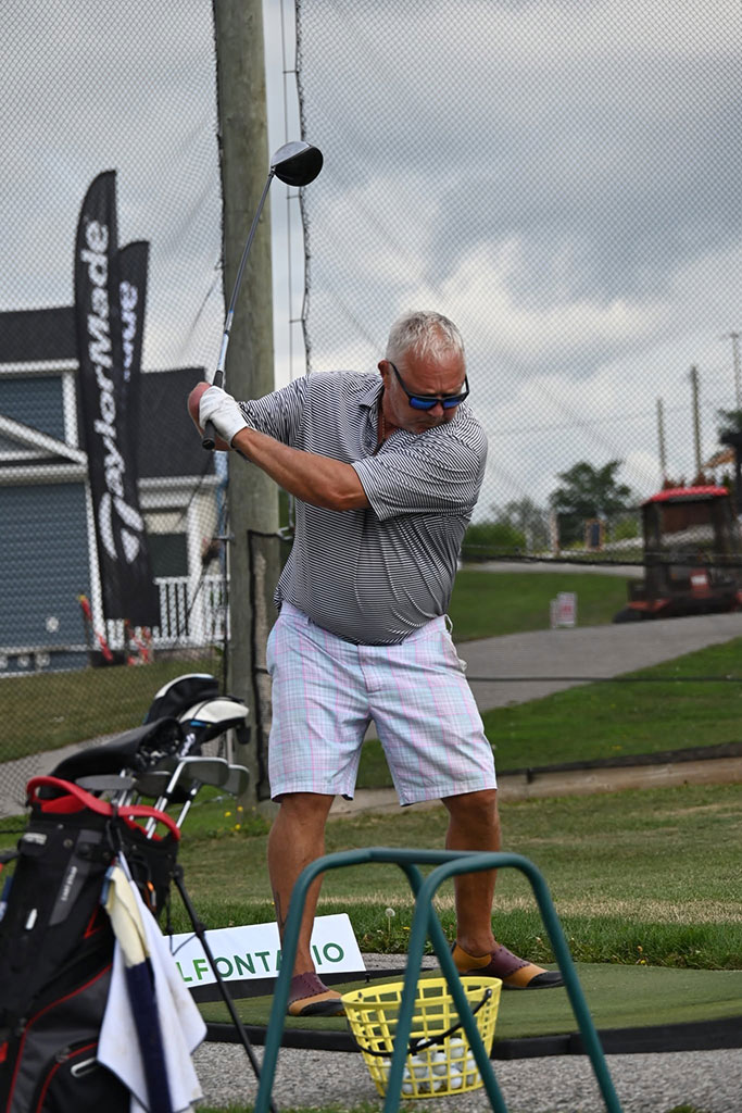 Amputee Golfer swinging at a golf ball